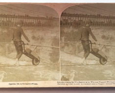 Clifford Calverley pushes a wheelbarrow across the wire.