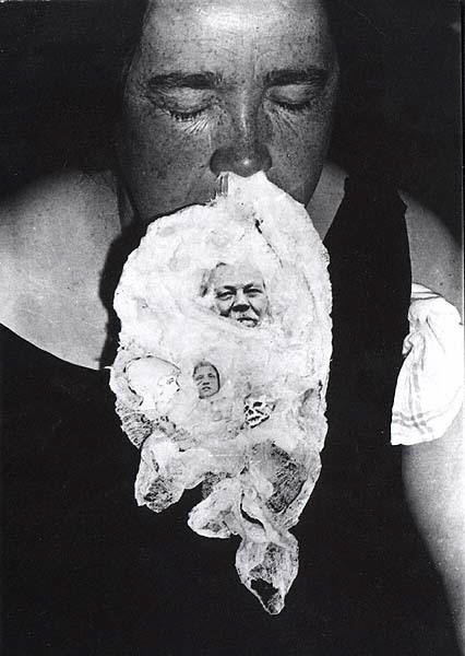 Fake ectoplasm came in different forms. Here, it's seen with faces, coming from Mary Marshall's nose during a séance at Hamilton House on June 27, 1932 taken by Thomas Glendenning Hamilton. Via Wikimedia Commons.